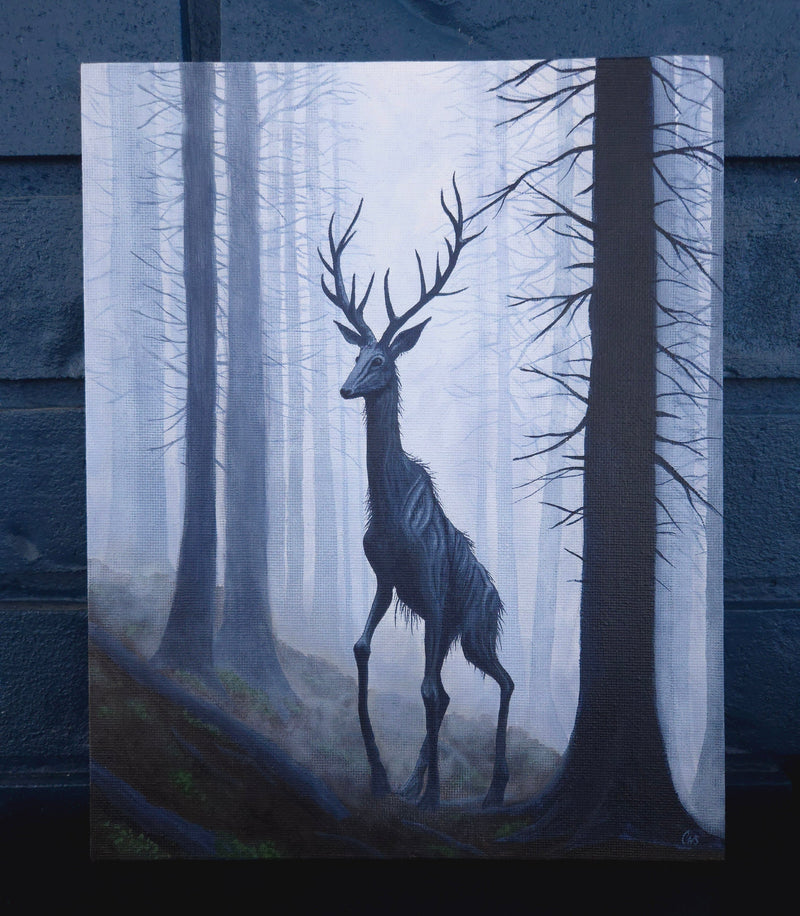 Silhouette of a spooky not deer in a forest with a blue tint