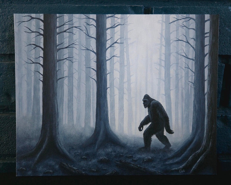 Silhouette of a bigfoot creature in a forest with foggy atmosphere