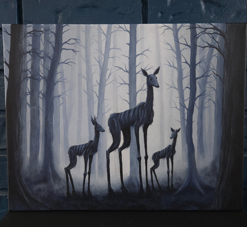 2 spooky not deer in a foggy forest. 1 mother and 2 babies