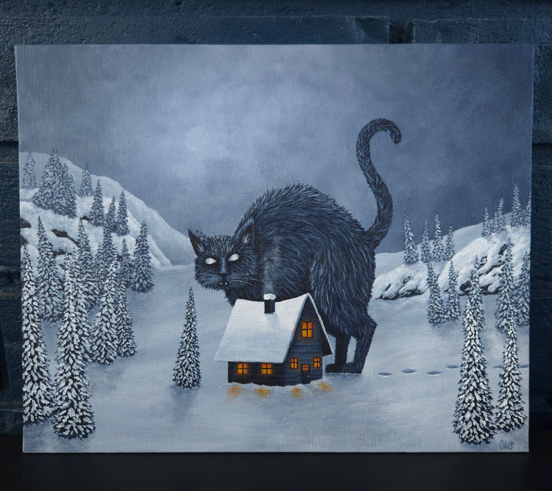 Illustration of a black yule cat with a house   surrounded by trees and a house in the foreground