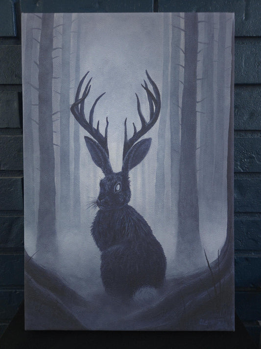 canvas print of a rabbit with antlers, a jackalope, in a forest setting