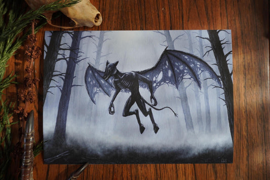 Artistic depiction of a winged creature in a forest setting on a wooden surface. the jersey devil in the pine barrens